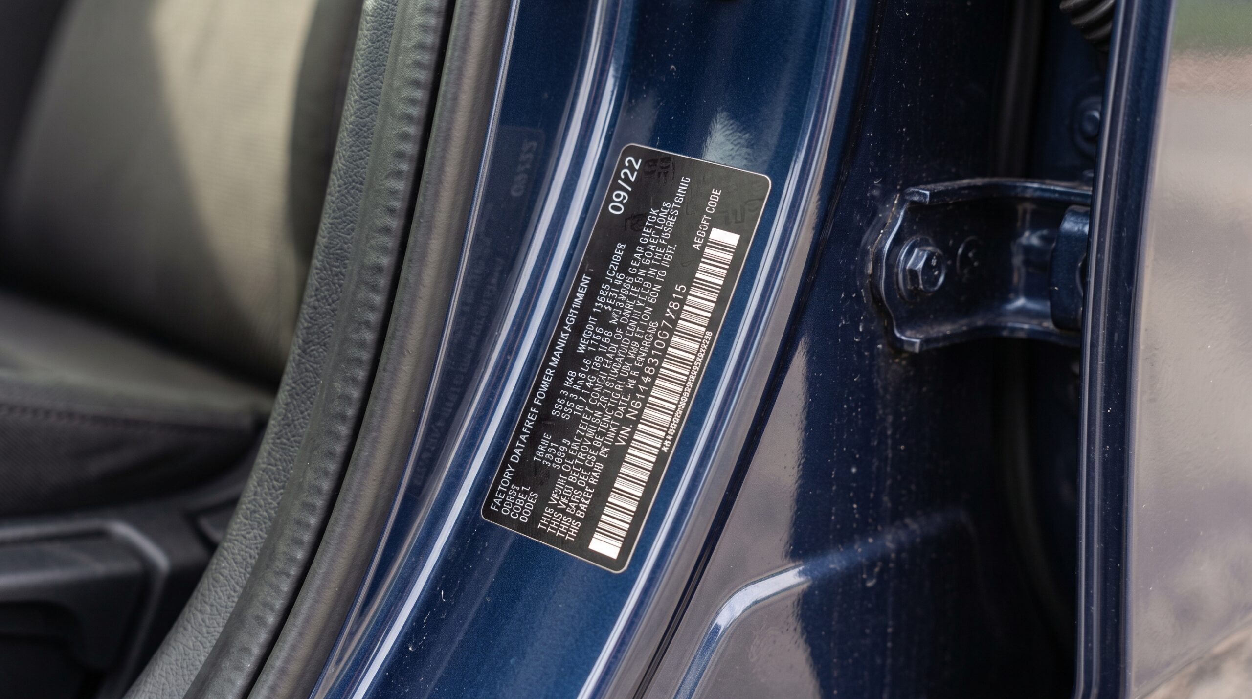 The build-date sticker inside the door jamb is the one label that tells you where a car actually sits inside its generation.