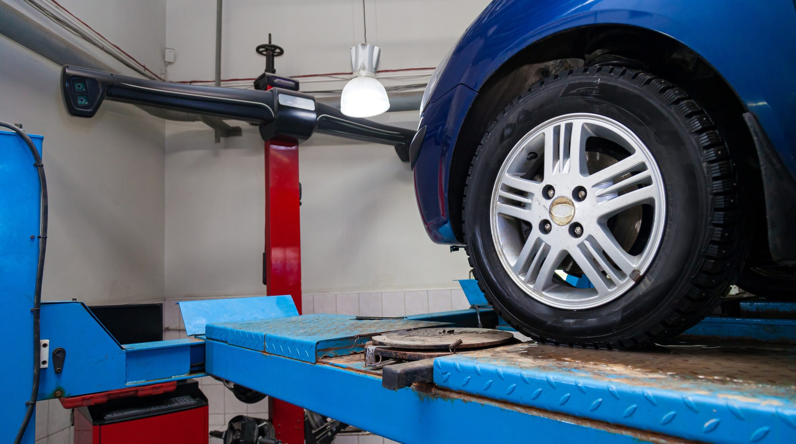 A wheel alignment rack measures suspension angles that no mileage schedule can predict.